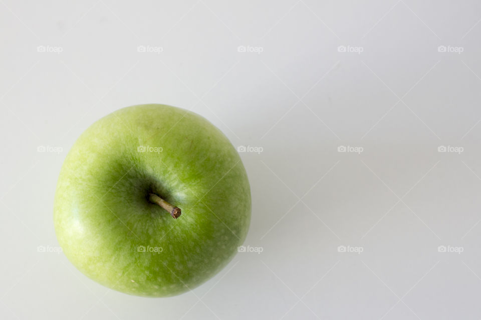 Green apple from above, white background 