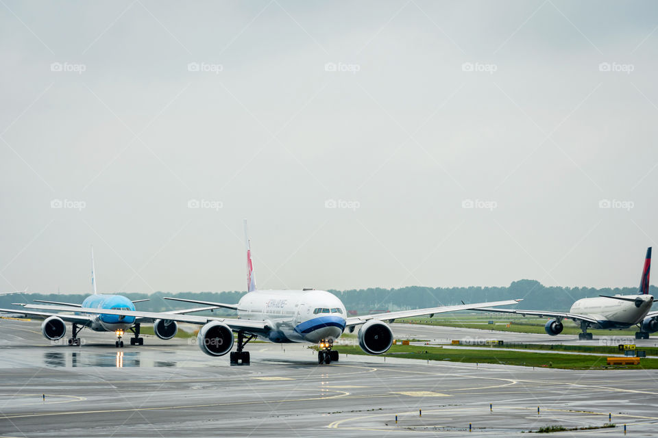 several aircraft down the runway goes in line for departure