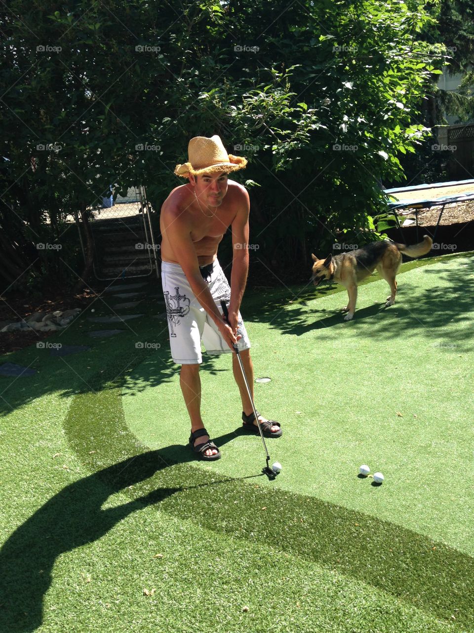 Cowboy playing mini golf