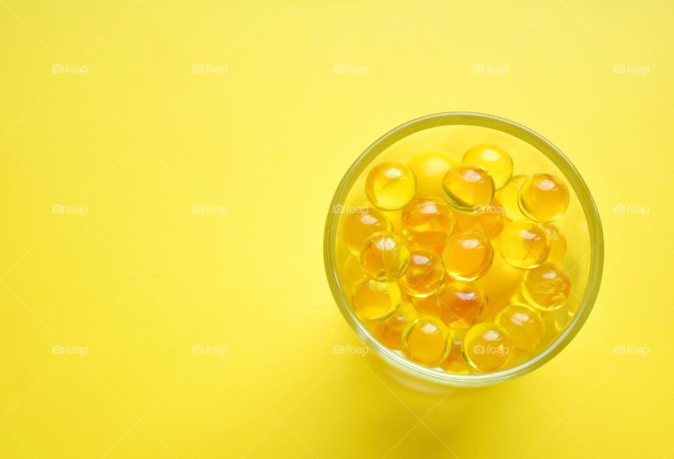 yellow vitamins capsules oils round beautiful texture yellow 💛 background