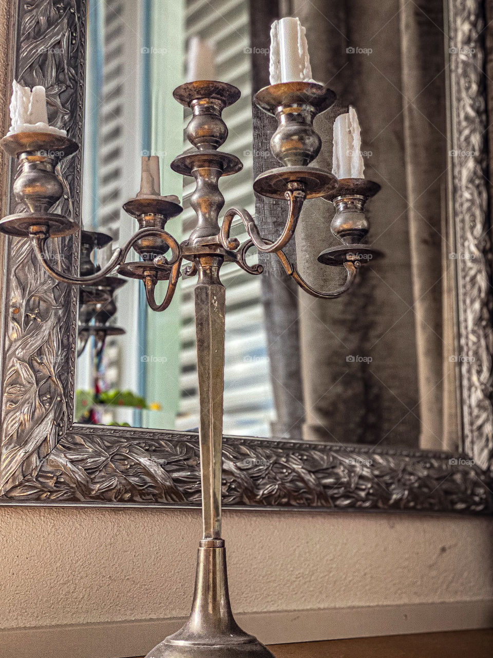 iron candlestick by the mirror, candlestick with white candles, mirror, reflection in the mirror