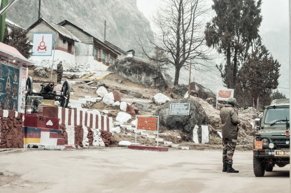Nathu La, Sikkim, Jan 2019: An Indian BSF army major watches Indian post at a 14,500 Ft high mountain pass on "McMahon" line in Indo Nepal and Indo Bhutan border area on way through himalayan roads.
