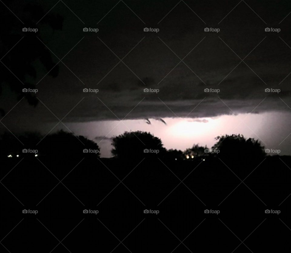 Lightning from thunderstorm, with possible funnel clouds.