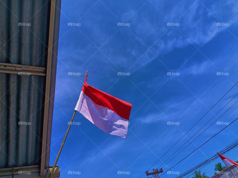 Indonesian Flag, The Red and white Flag, national symbol of Indonesia. Red and white pennant or flag on a bamboo
pole used to commemorate Indonesia's
independence day