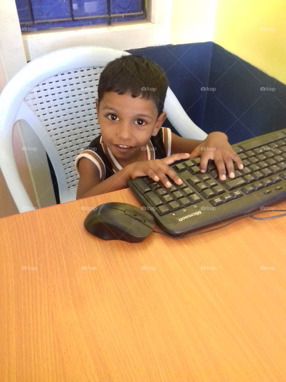 cute baby typing computer keyboard with mouse
