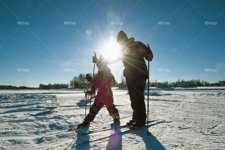 Cross country skiing. Family skiing activity. Mommy and her daughter on ski trip.