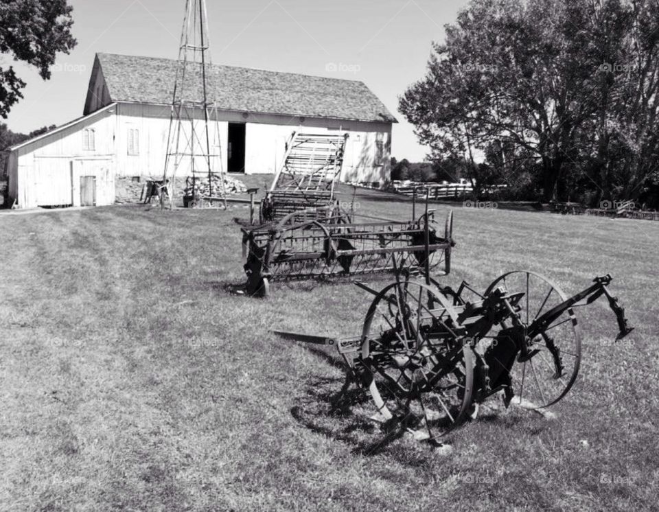On the farm. Rural area , farm with equipment on lawn , simple life , hard workers..