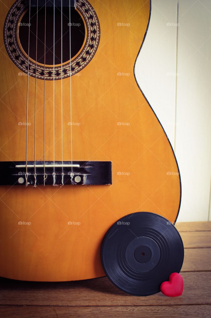 Guitar love. A guitar, a vinyl record and a red love heart 