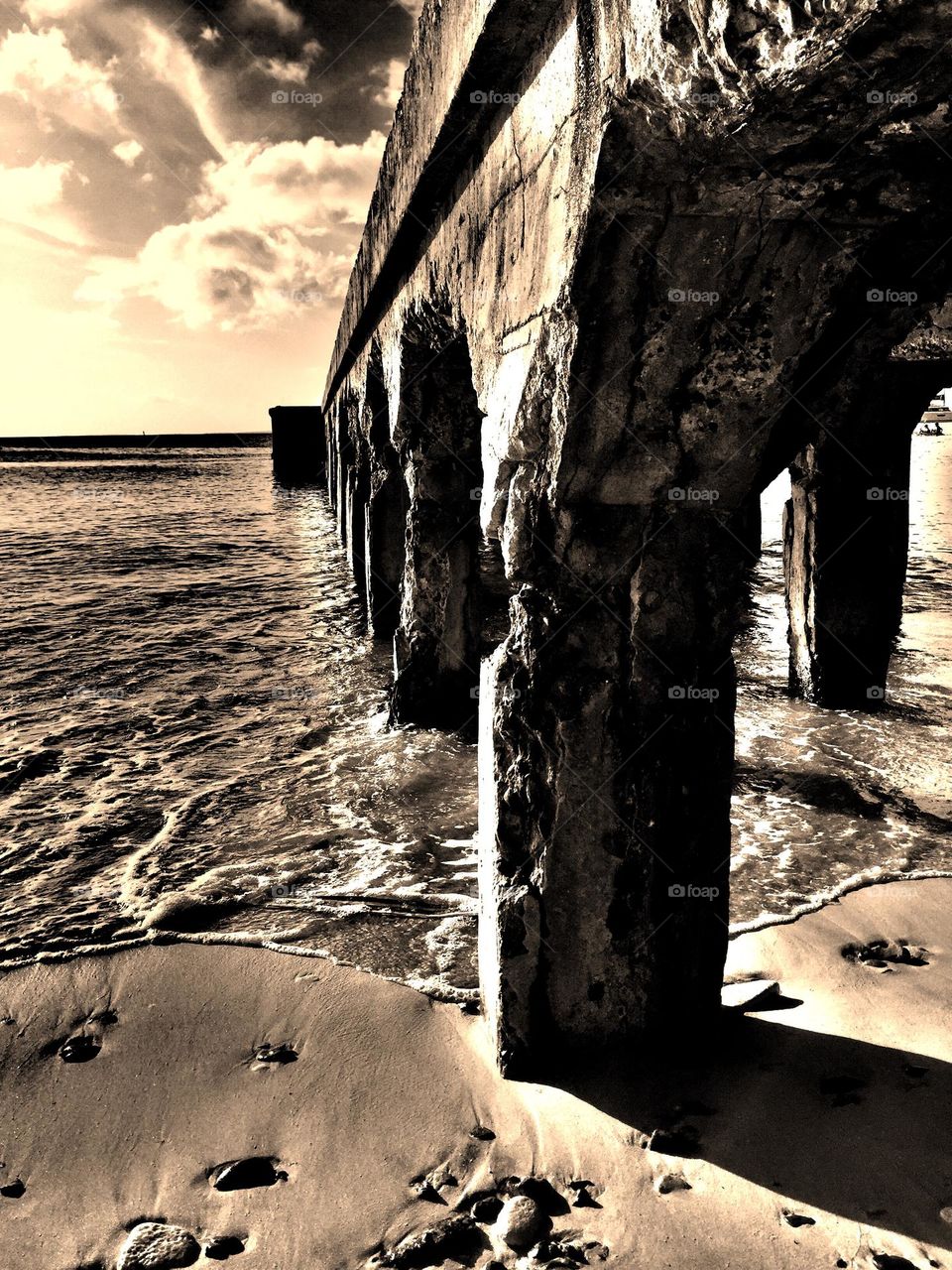 Monochrome pier by the ocean, Grand Case St. Maarten pier by the beach, beach view, view from beneath the pier 