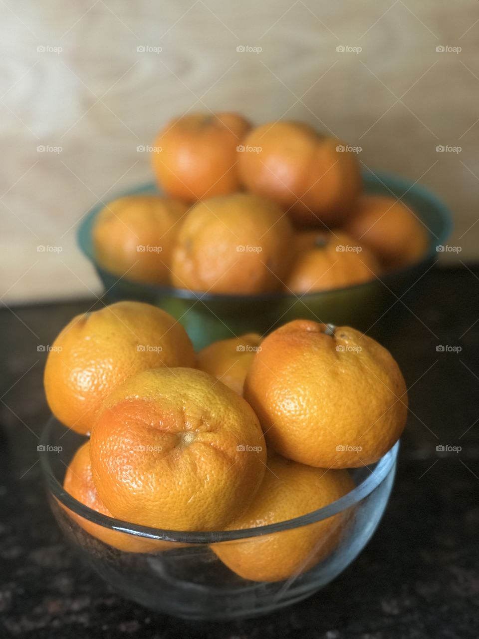 2 bowls of Oranges on display on the countertop in the kitchen - fresh fruit 