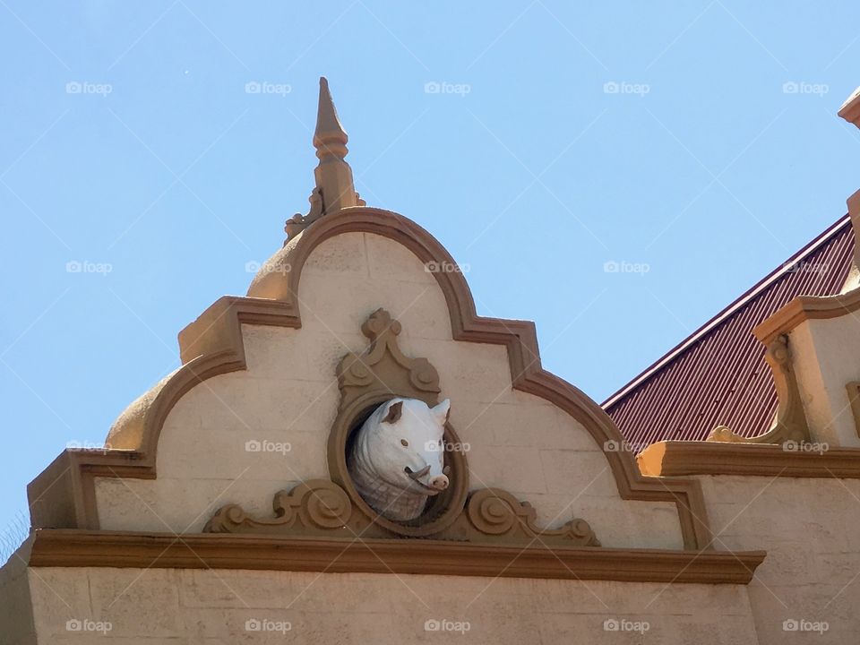 Boar's head pigs head detail on pub building facade