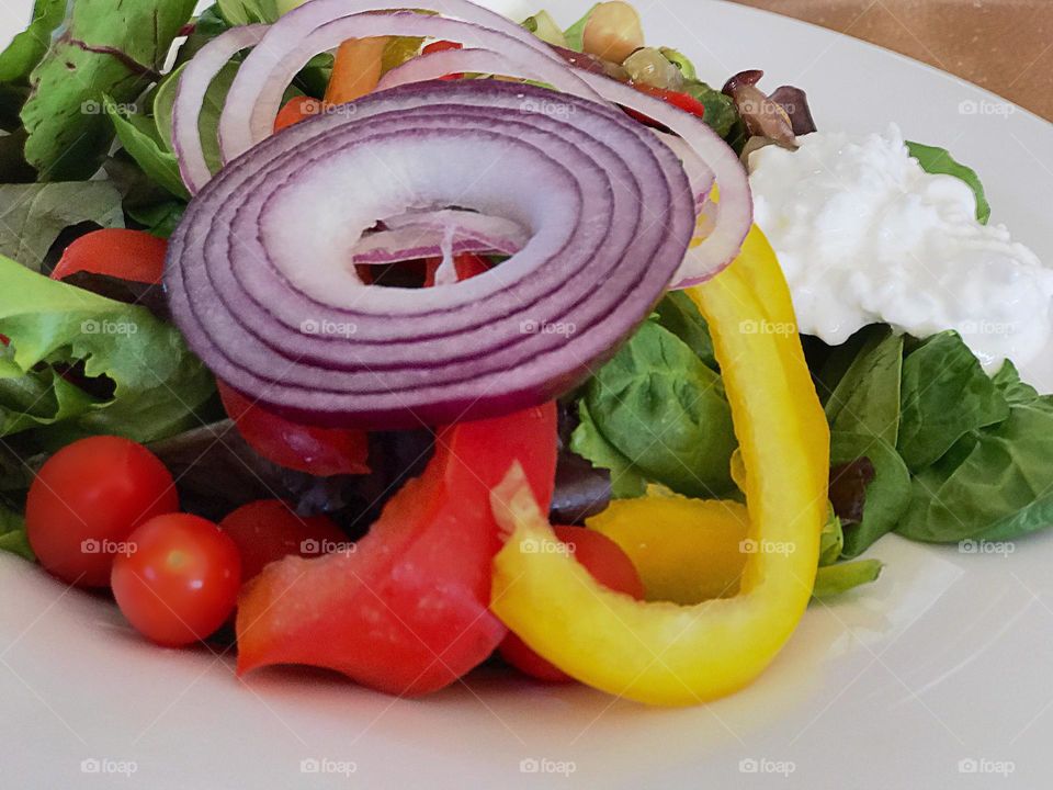 Red and yellow peppers , onions and tomatoes together make a great salad.