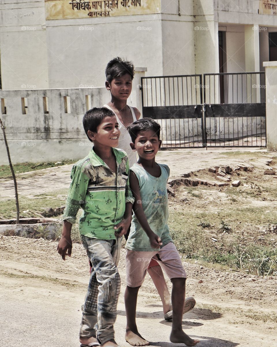 Children walking while smiling. 