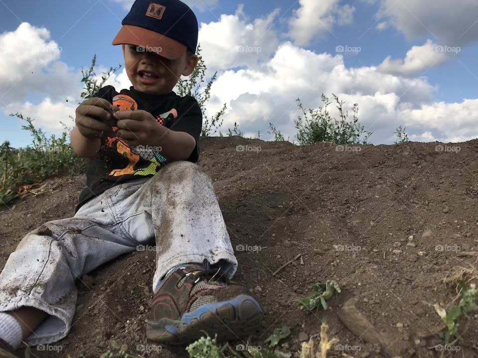 Young boy playing in dirt
