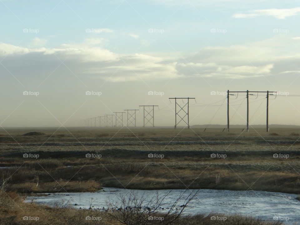 Power lines fading into the morning mist. Iceland.