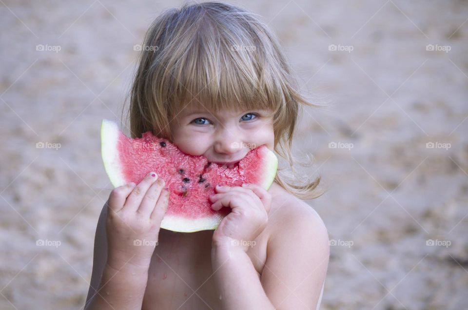 child eating watermelon