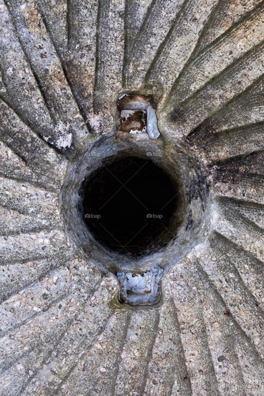 Center of a stone grinding wheel used to grind corn and wheat many years ago in an old gristmill. Historic Yates County Park in Raleigh North Carolina.