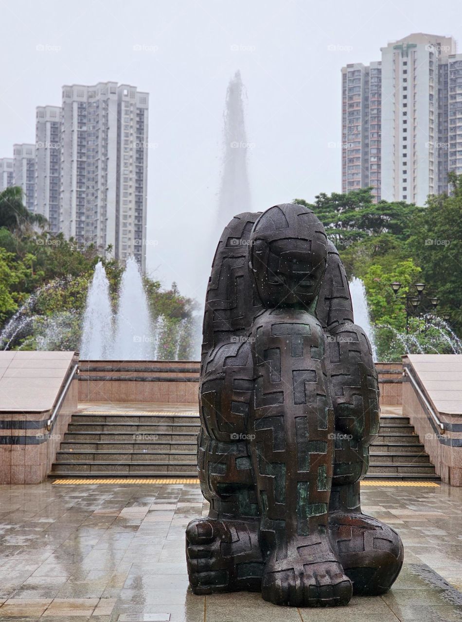 Statue and water fountain at park in Hong Kong