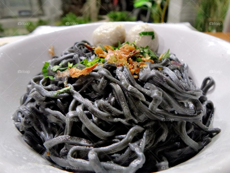 black noodles and small meatballs