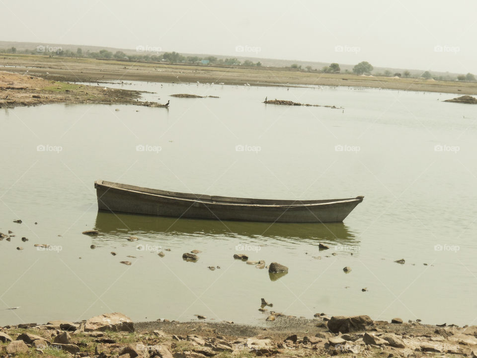 Boat in a dry pond. Natural view