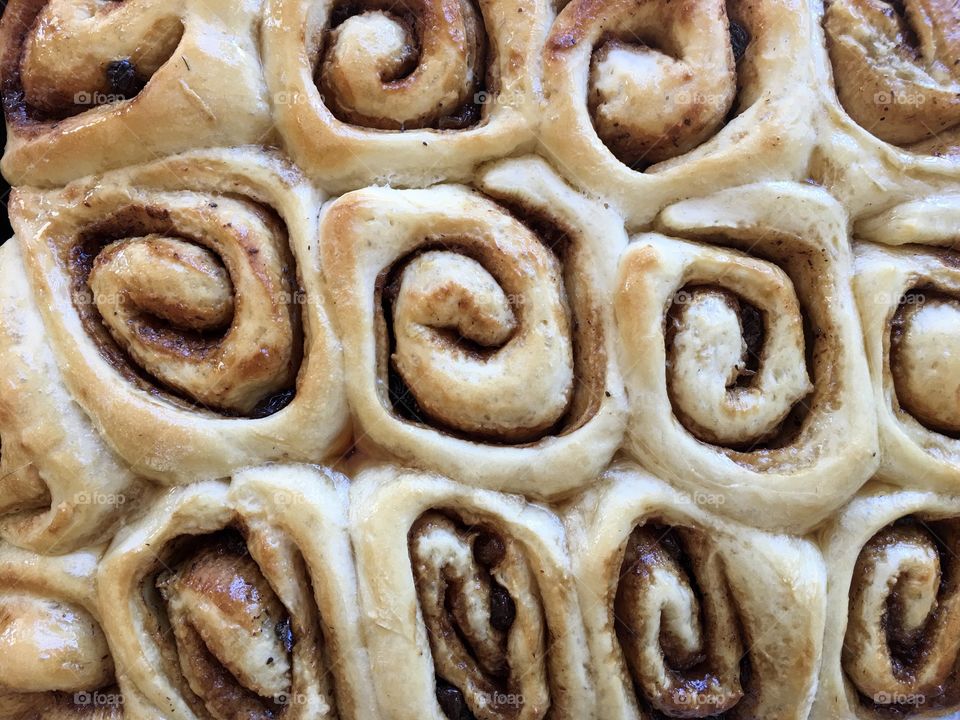 Maple syrup glazed homemade cinnamon rolls scrolls