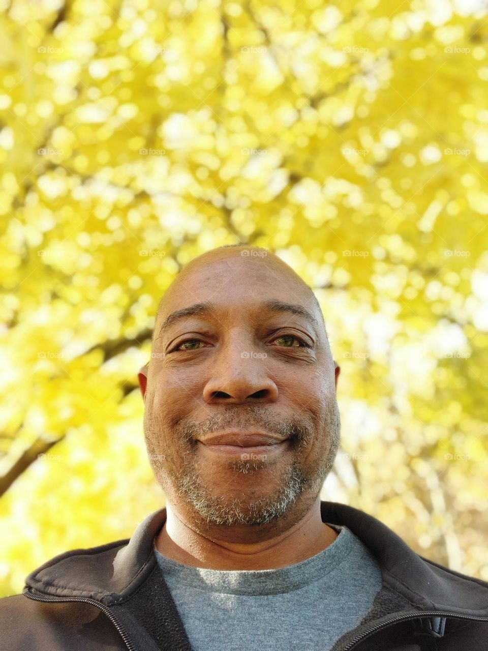 Self-portrait of a photographer with yellow fall leaves in the background in the city of Sacramento California