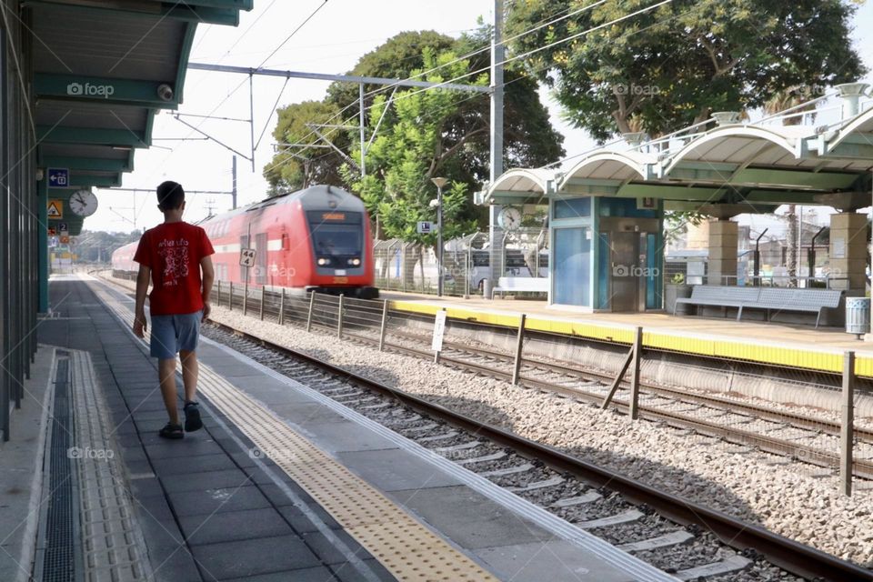 Kid walking on the platform in the rail station 