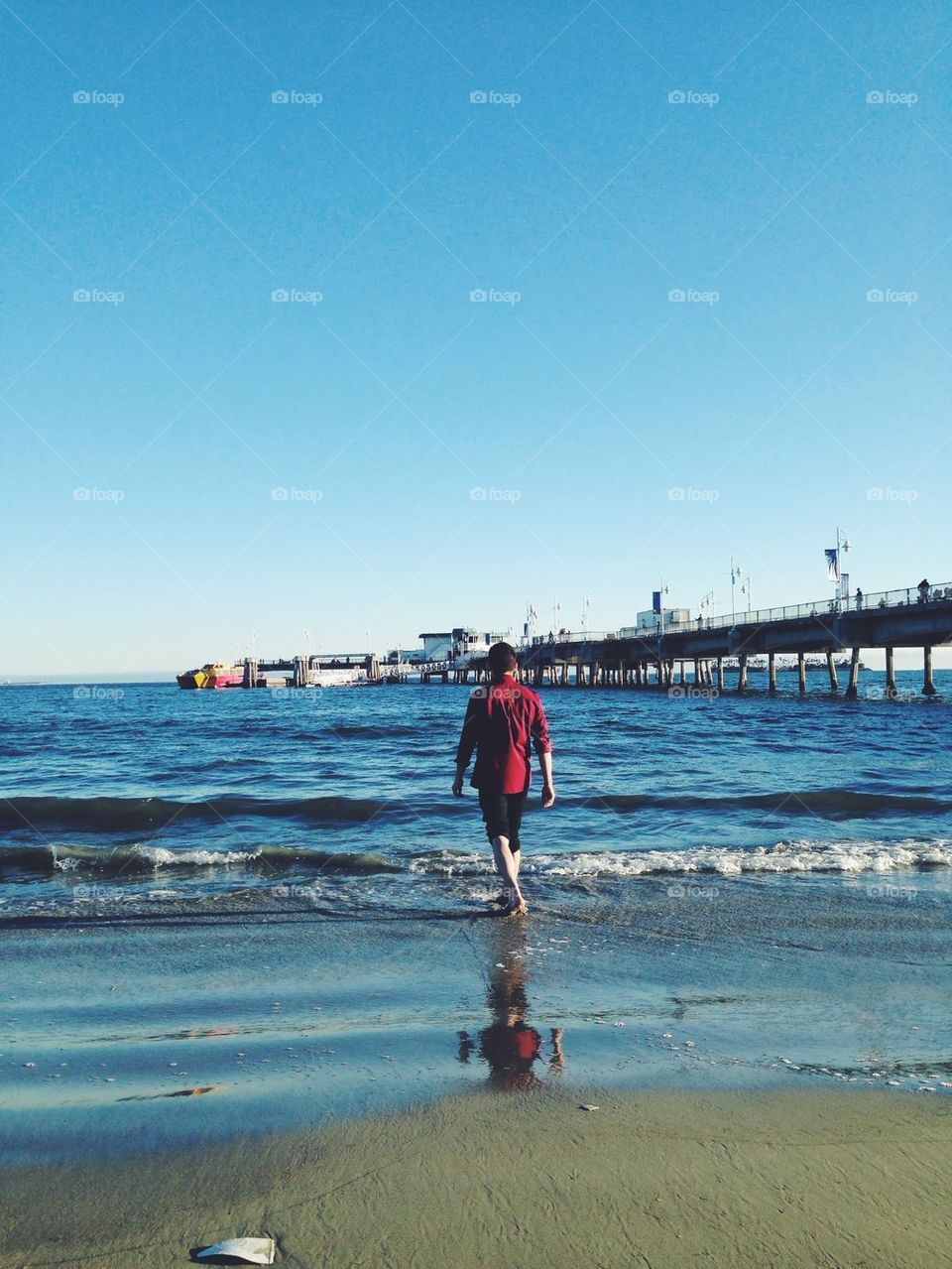 Man walking into ocean