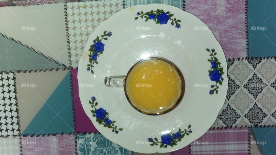 Cup of orange juice in a dish