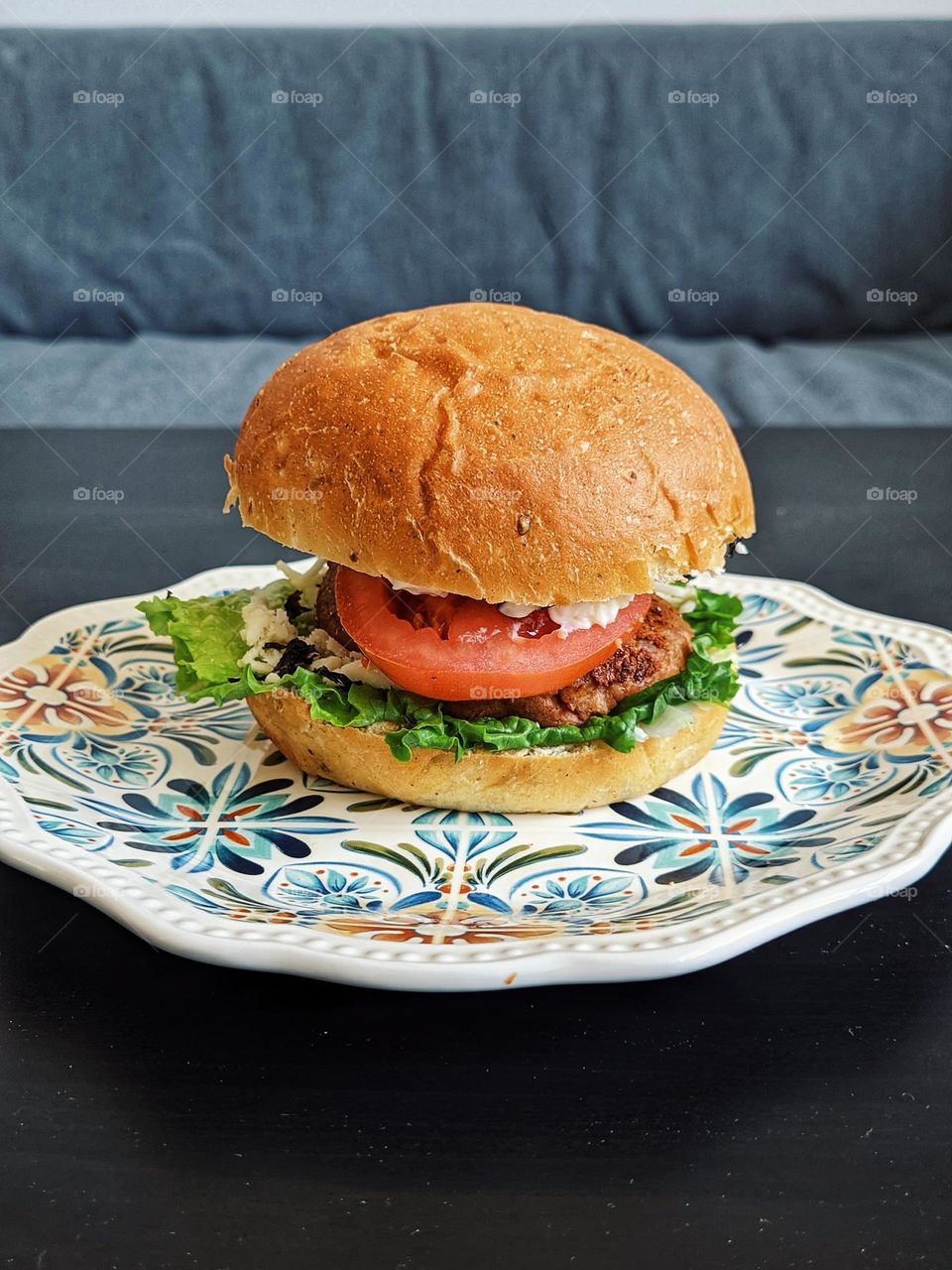 Top view of veggie burger with lettuce,  tomato and cheese close up. Lunch time