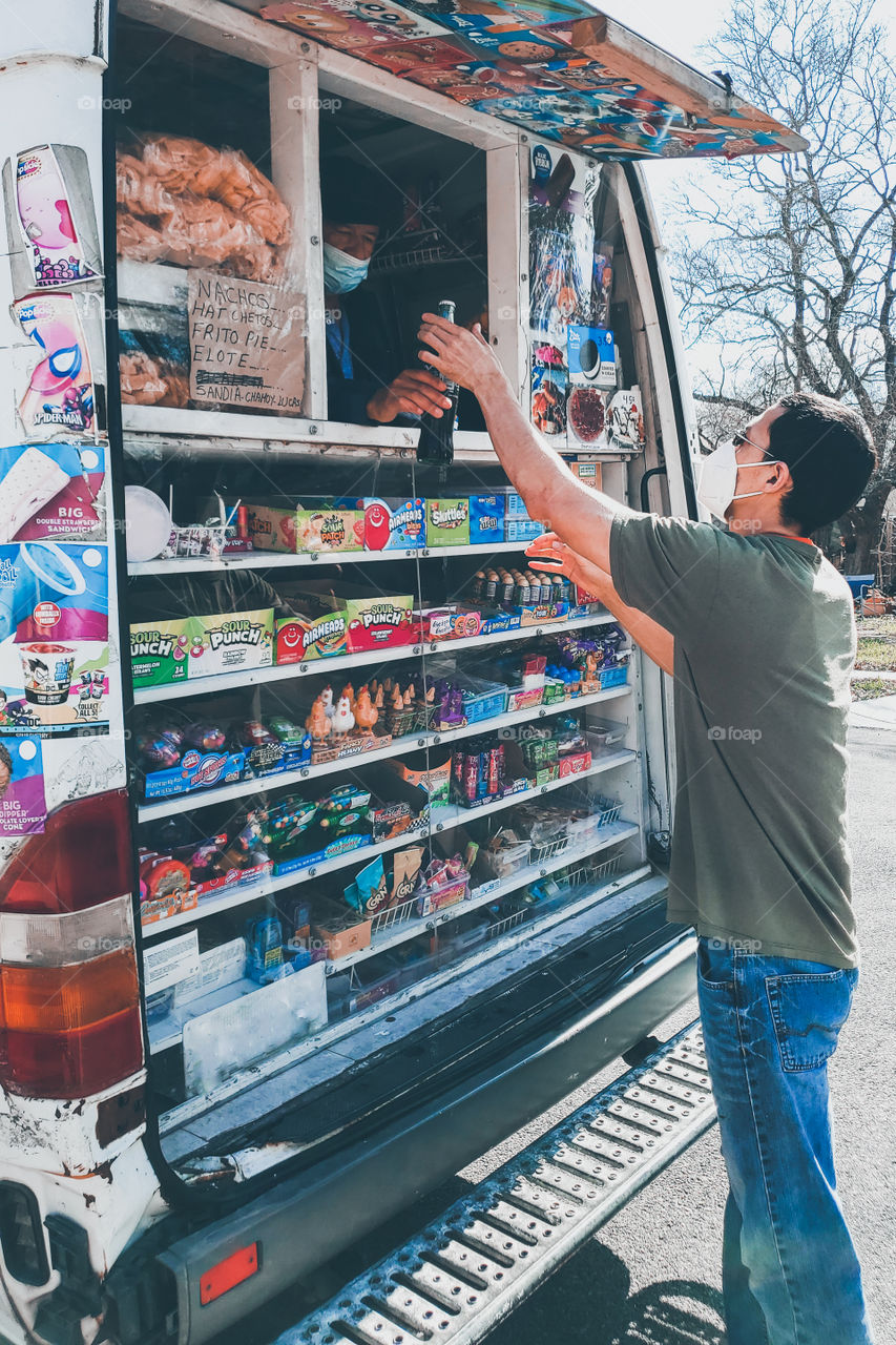 Man buying a bottle of Coca-Cola from the ice-cream truck during the 2021 pandemic.  no. 4