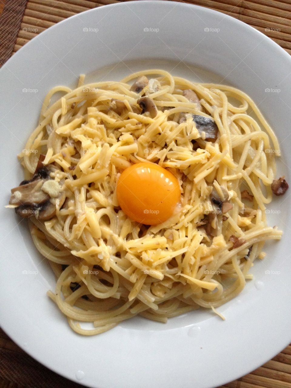 Homemade pasta with mushrooms, cheese and yolk 