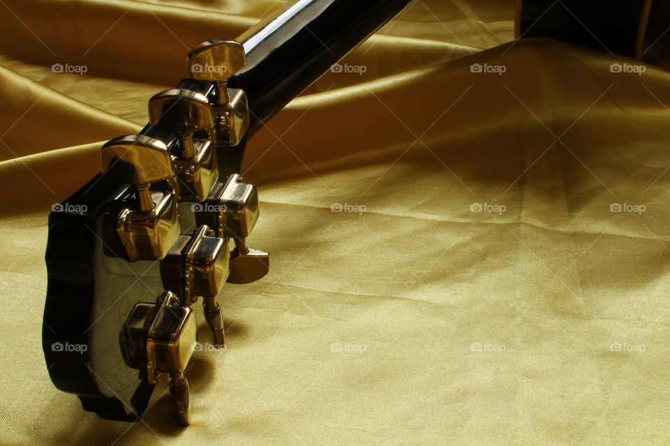 acoustic guitar on Golden textile