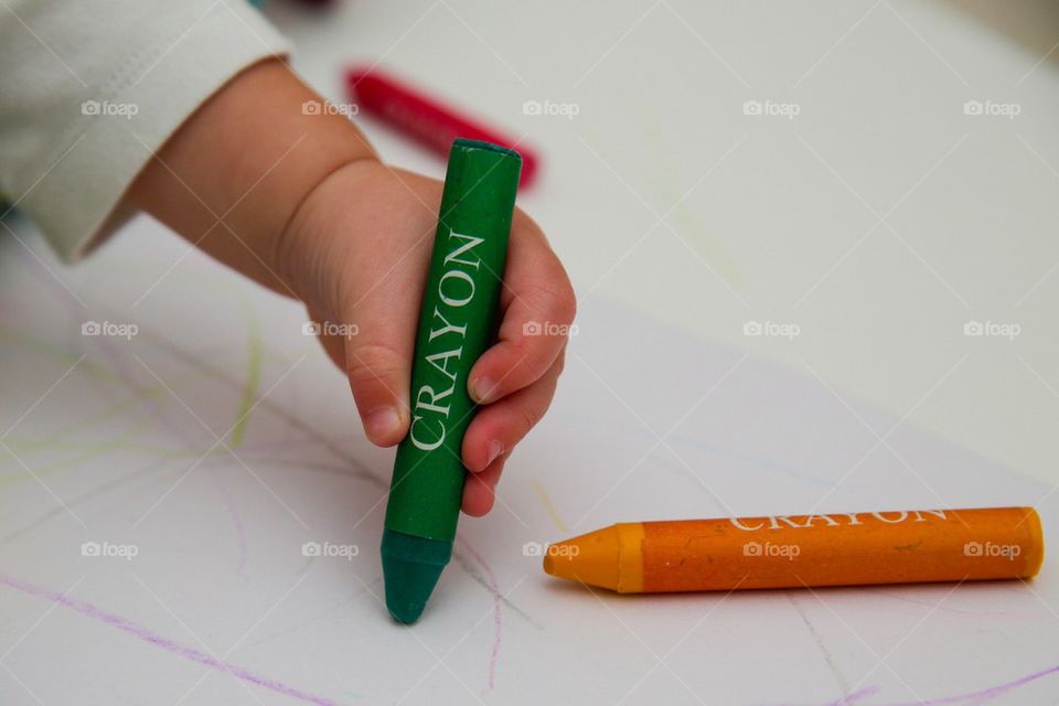 Toddler using a crayon