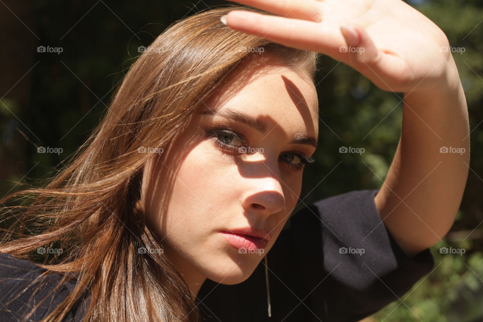 portrait photo of a young woman with bright makeup