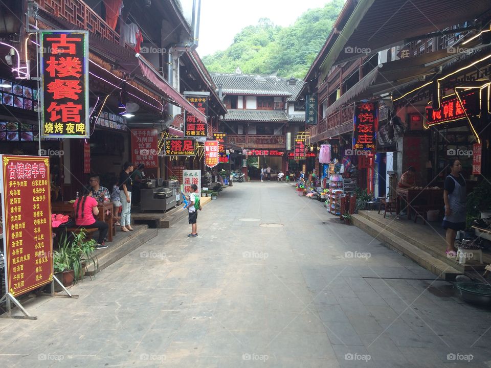 Chinese town street view, red signs, mother and son