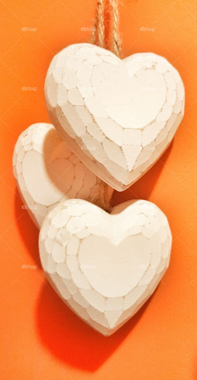 three hearts in an orange background