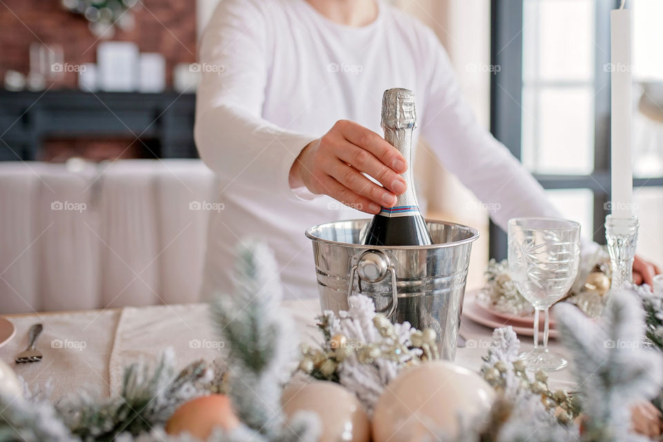 man sets a beautiful decorated winter table for a festive dinner.  Merry Christmas and Happy New Year.