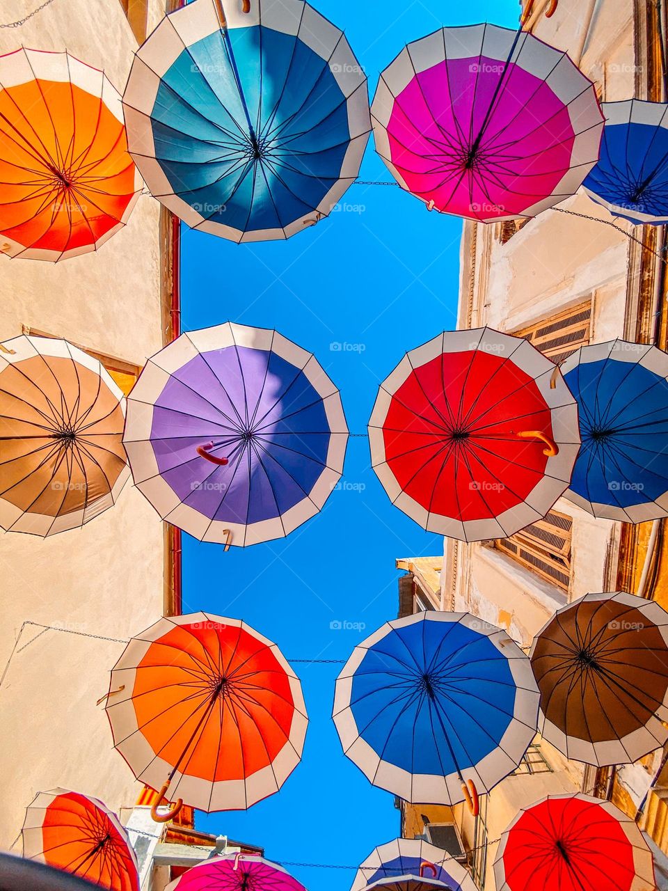 Bright colored umbrellas under the blue sky 