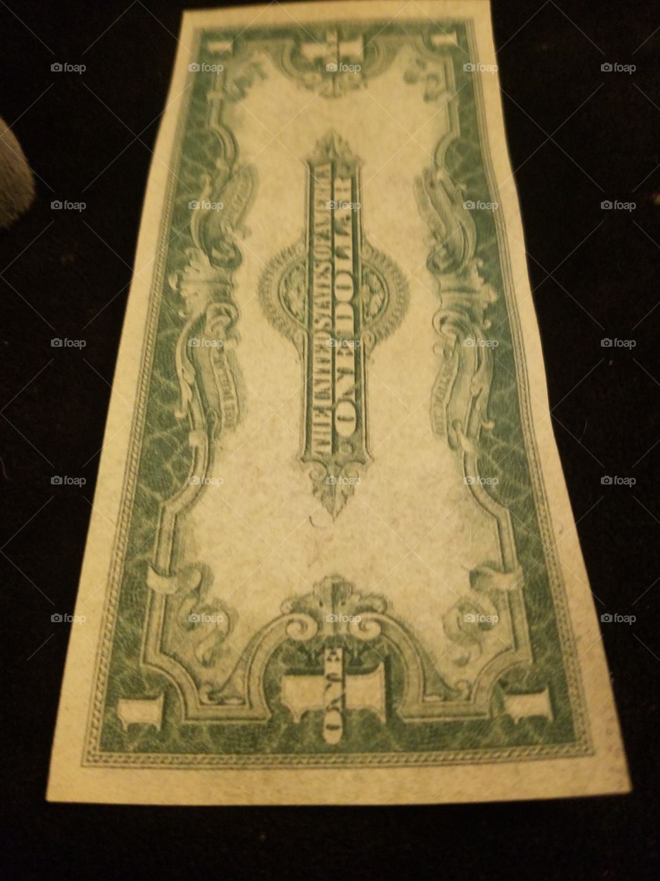 The single most common large size piece of United States currency is the 1923 $1 silver certificate.  These were issued by the millions.  reverse side