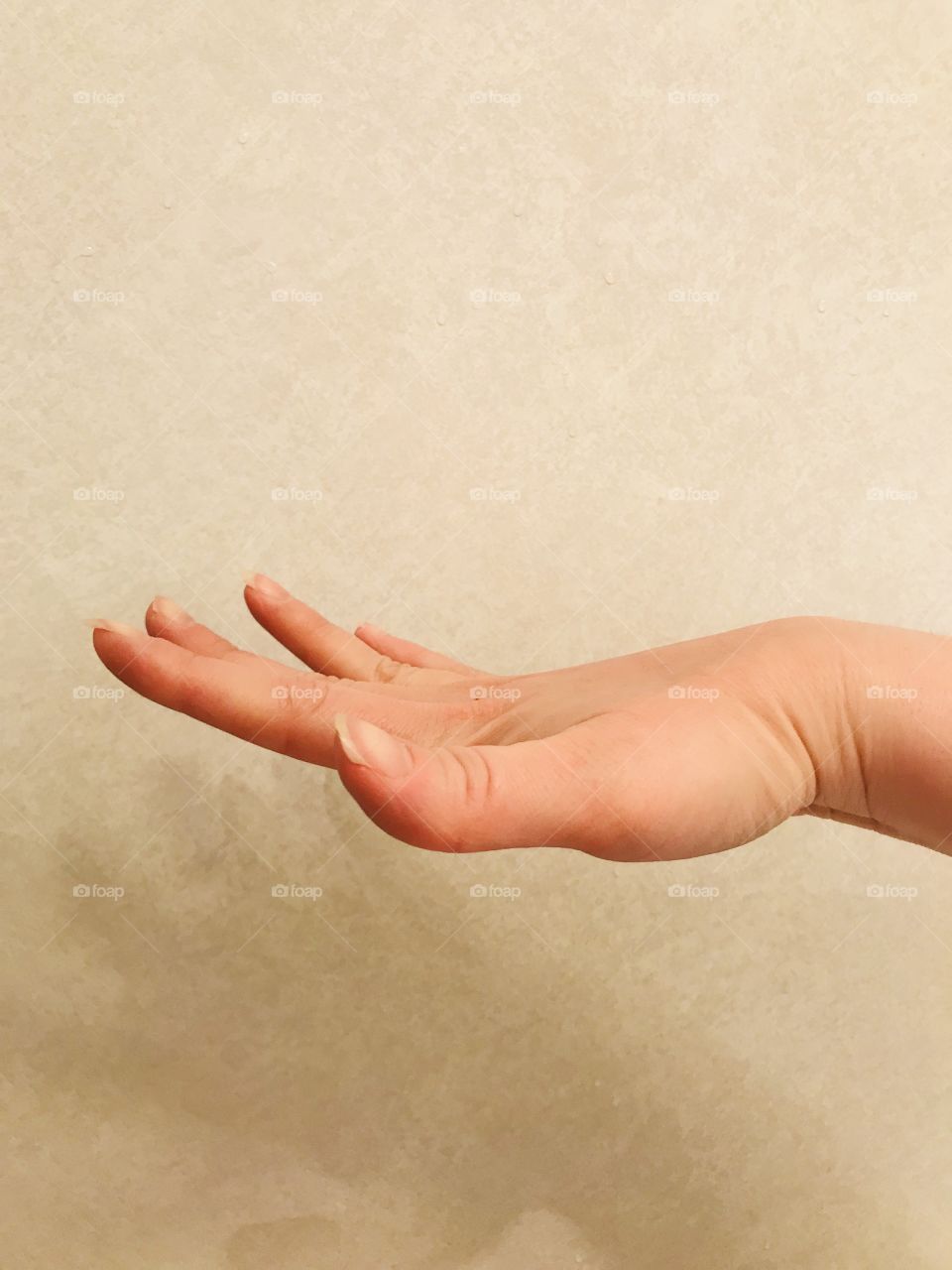 Adult woman demonstrates hand flexibility and hypermobility with “flying bird hand sign” 