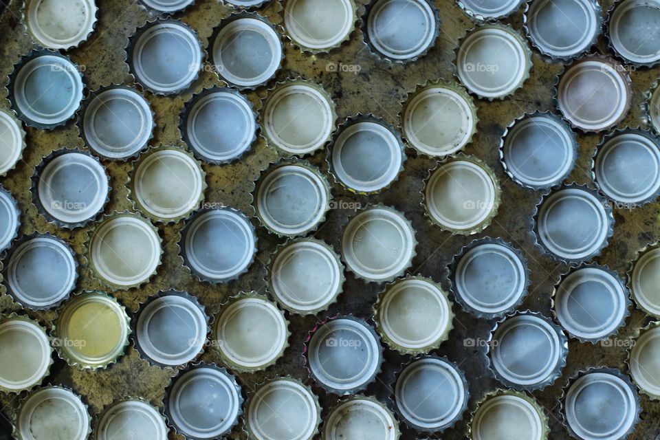 Close up of many bottle caps directly above 