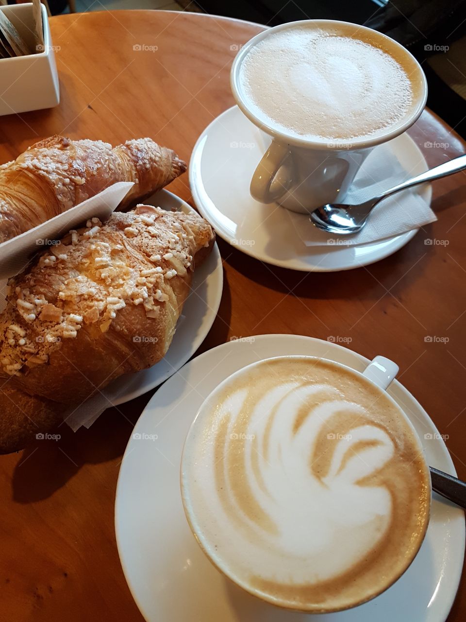Cup of coffee with croissant