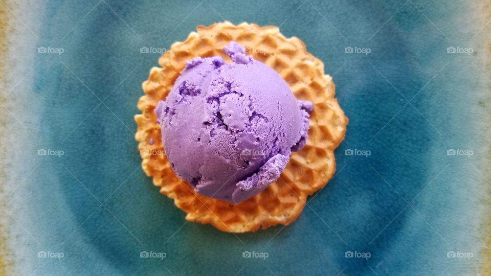Purple ice cream scoop on waffle