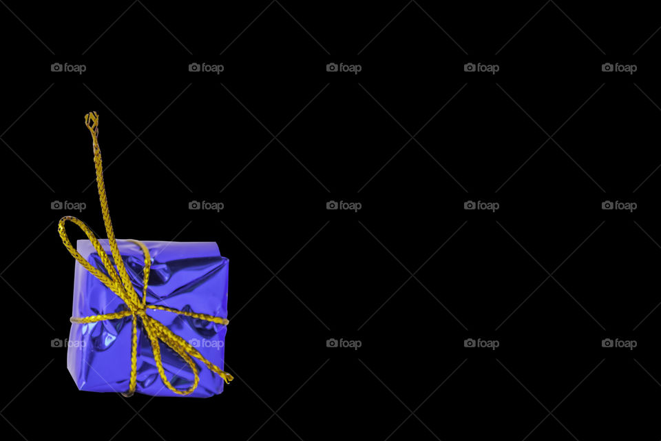 Isolated Gift box blue for the festivities on a black background with clipping path.