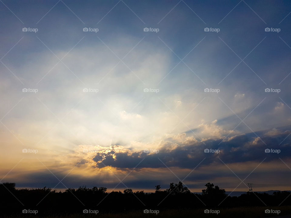 sunrise behind some clouds