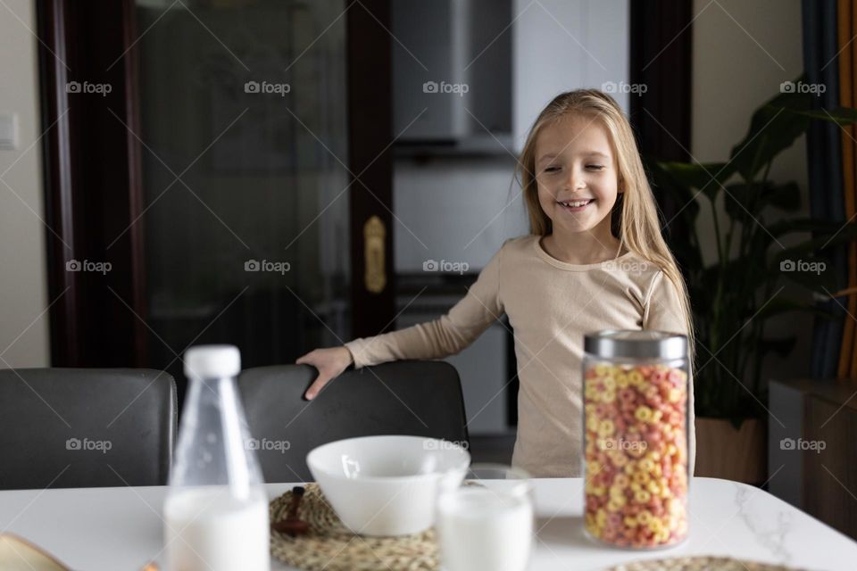 Little girl ready to eat breakfast on kitchen 