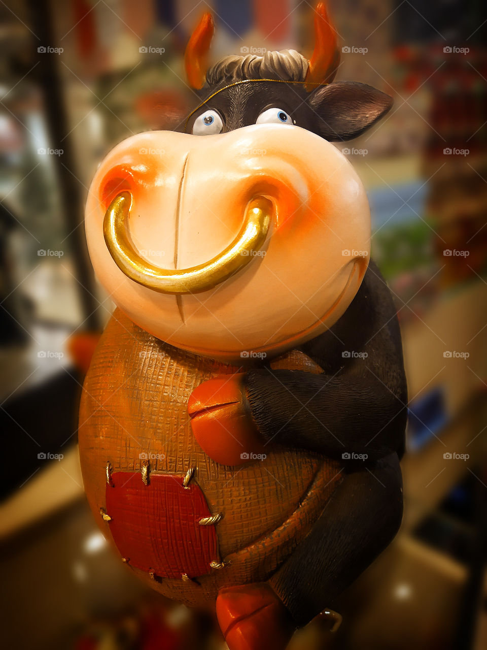 Stylish cow.  Statuette of a cow that smiles