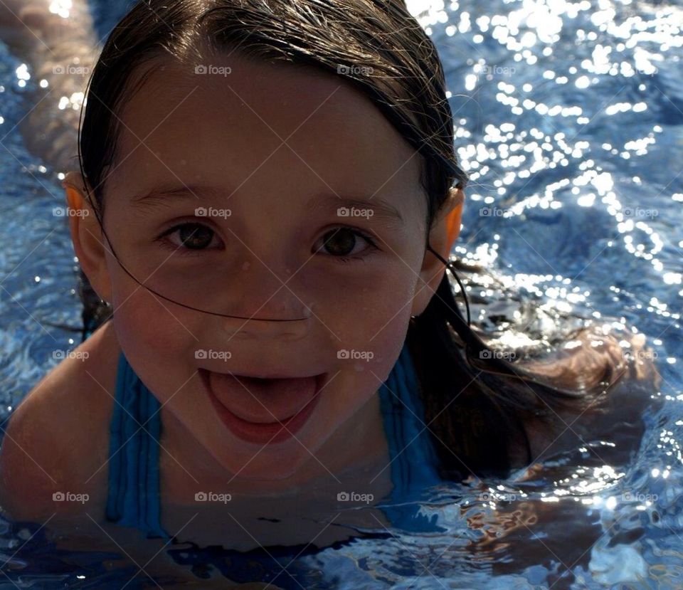 Adorable girl taking a swim