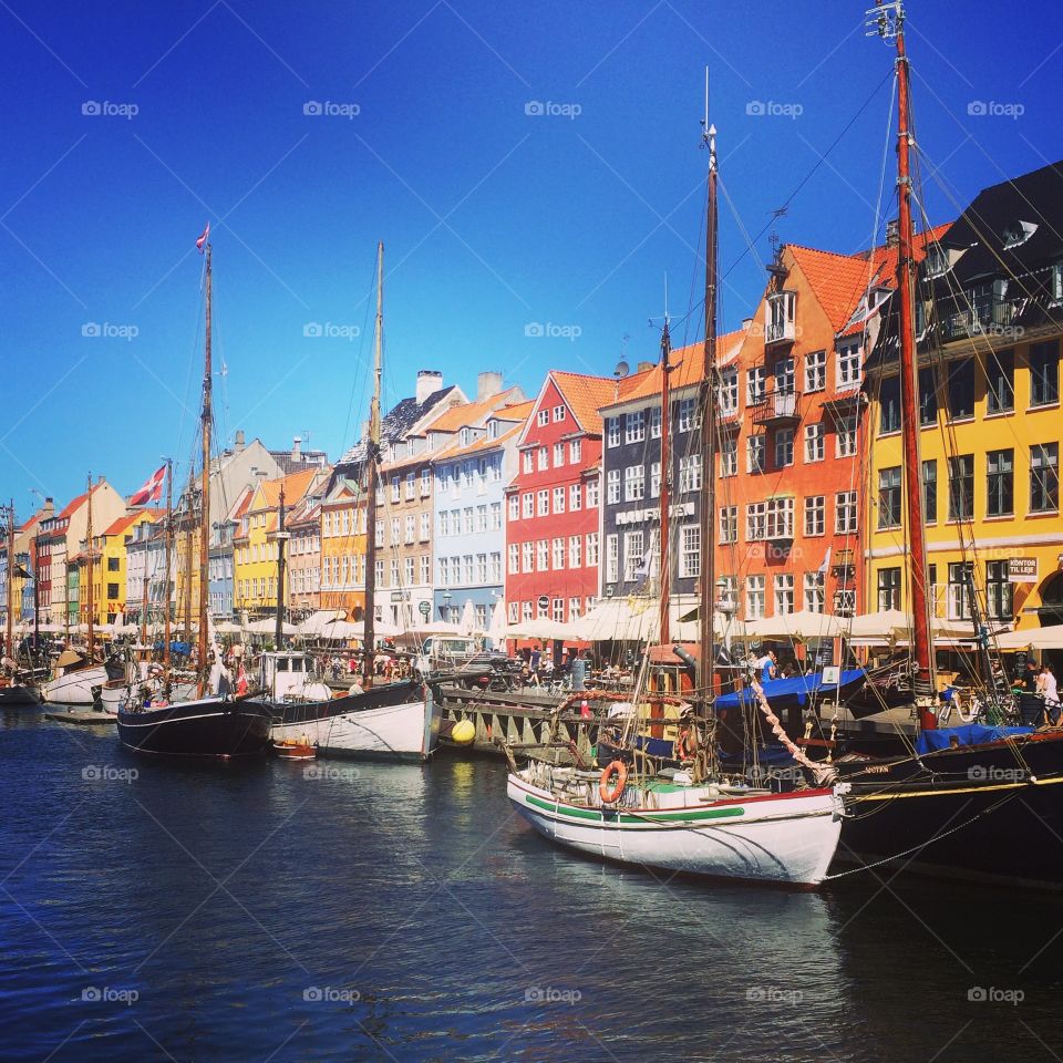 Boats moored at harbor in Nyhavn